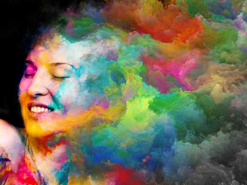 Woman with smokelike variety of colors streaming from head to represent color psychology