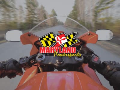 First person view on a red sports motorcycle. Sportbike in the first person. with Maryland Powersports logo