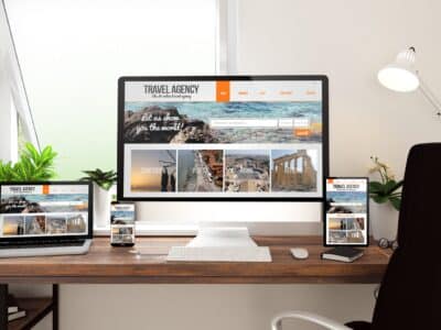 Windowed home office with travel agency website on desktop, laptop, table and mobile device