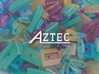 Large quantity of plastic caps with Aztec Industries logo