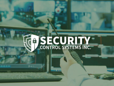Security guard watching video and using monitoring system with SCSI logo overlay