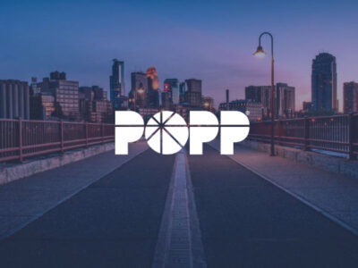 POPP Communications logo with Minneapolis skyline in background
