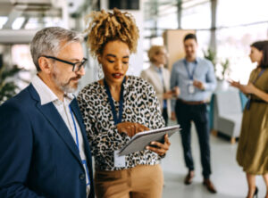 Man and woman looking at iPad in office