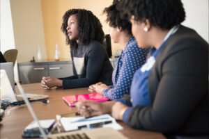 African American business women talking at conference table