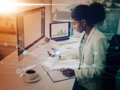woman at computer writing at desk for research, innovation and technology abstract