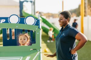 Caregiver on playground with small child