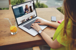 Female freelancer sitting at laptop looking at website