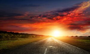 Paved country road at sunset