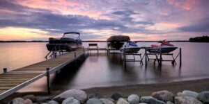 Boats/dock on a lake at sunset